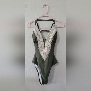 Green with white lace one piece bathing suit. Never worn